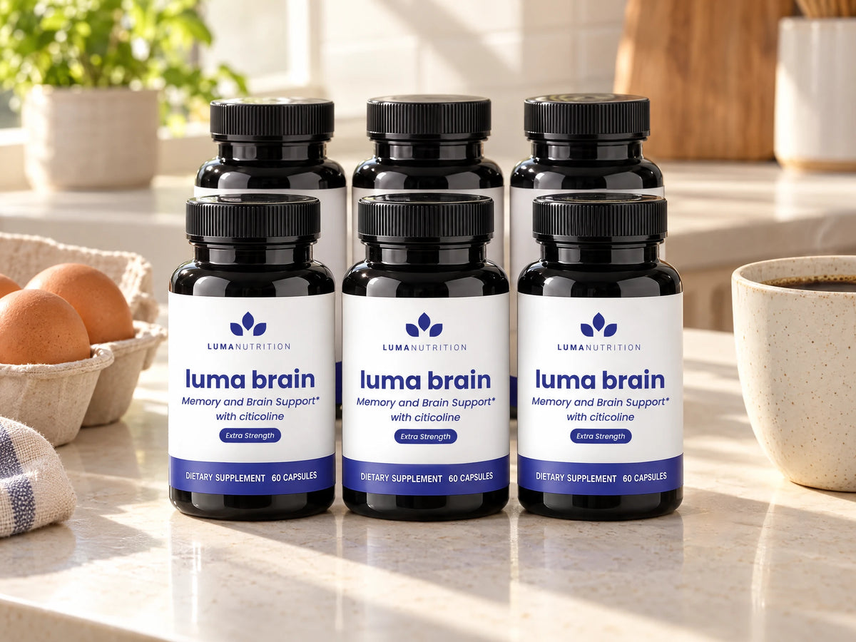 Six bottles of Luma Brain lined up on a kitchen counter beside an egg carton and a cup of coffee