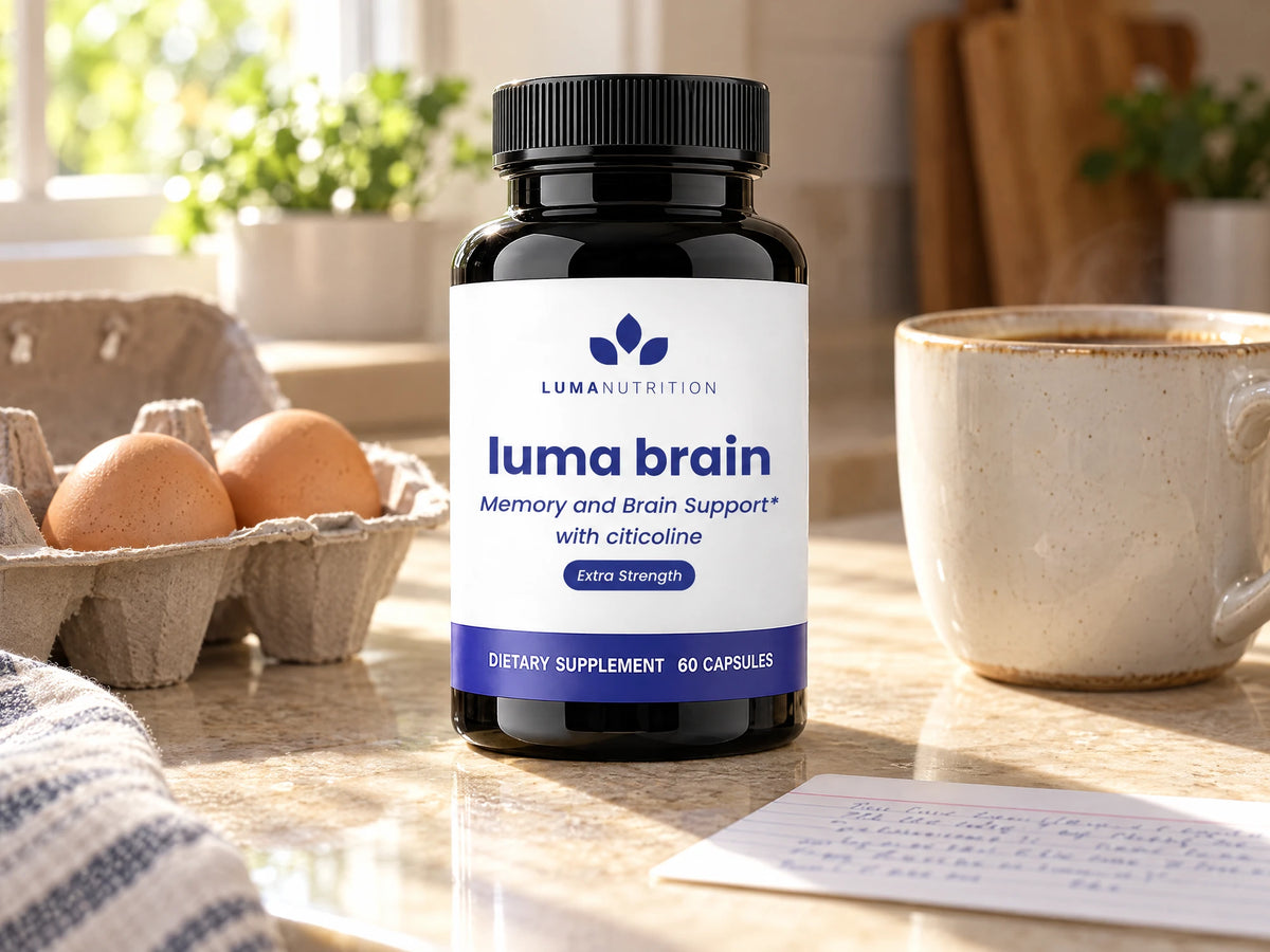 A bottle of Luma Brain with citicoline on a kitchen counter beside an egg carton, a cup of coffee and her index card