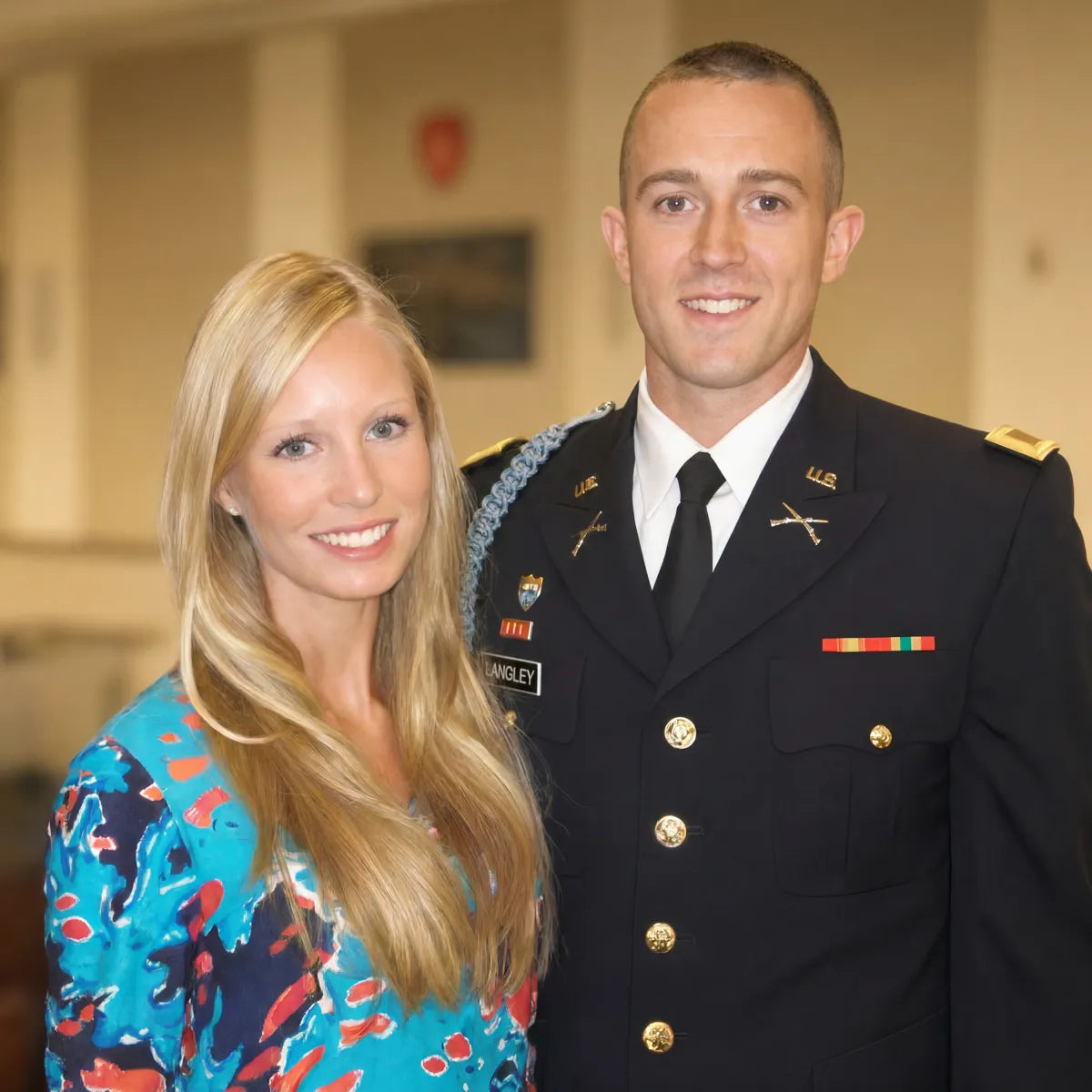 Jake Langley in Army dress uniform standing next to his wife